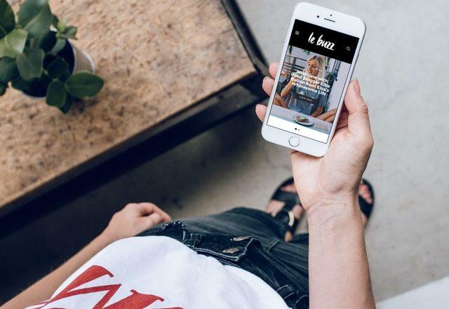 Blog 16 Woman holding phone with app open