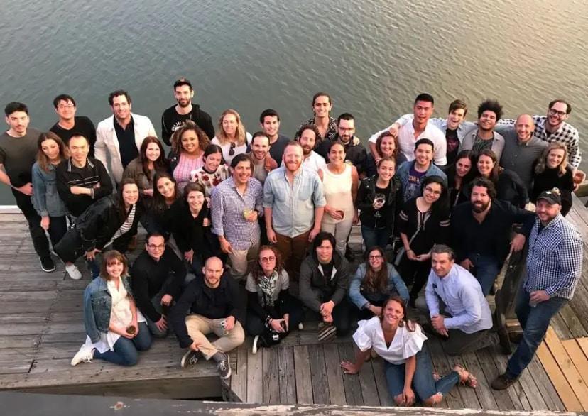 team | Los Angeles Software Developers Large group of people posing together outdoors on a wooden dock by the water